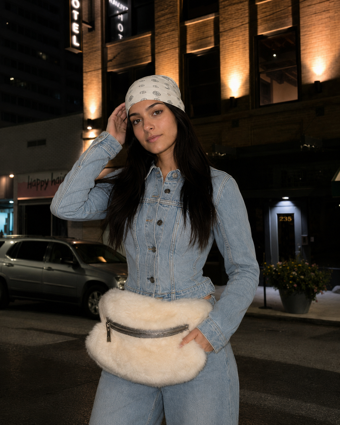 Close portrait of a woman in a light denim jumpsuit and patterned headscarf