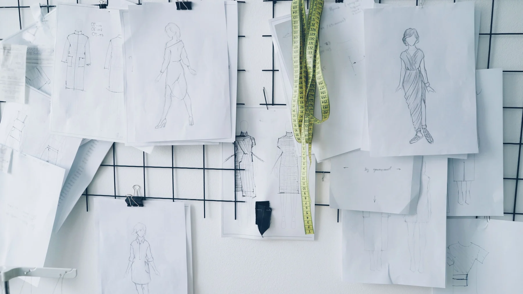 Wall of fashion sketches and garment studies